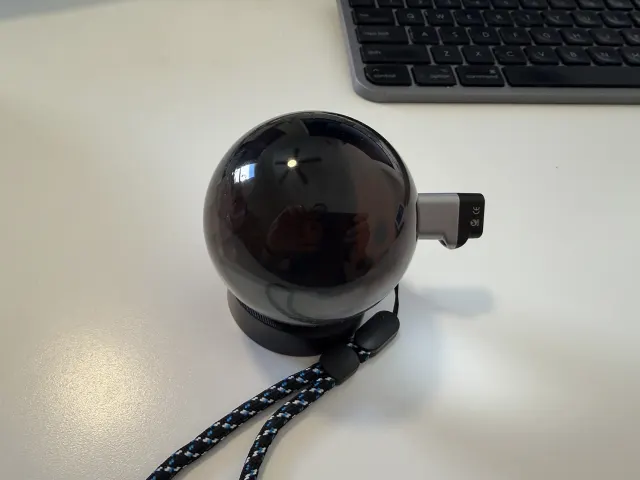 Memory Orb on its stand with a USB-C memory stick plugged in to load photos and videos